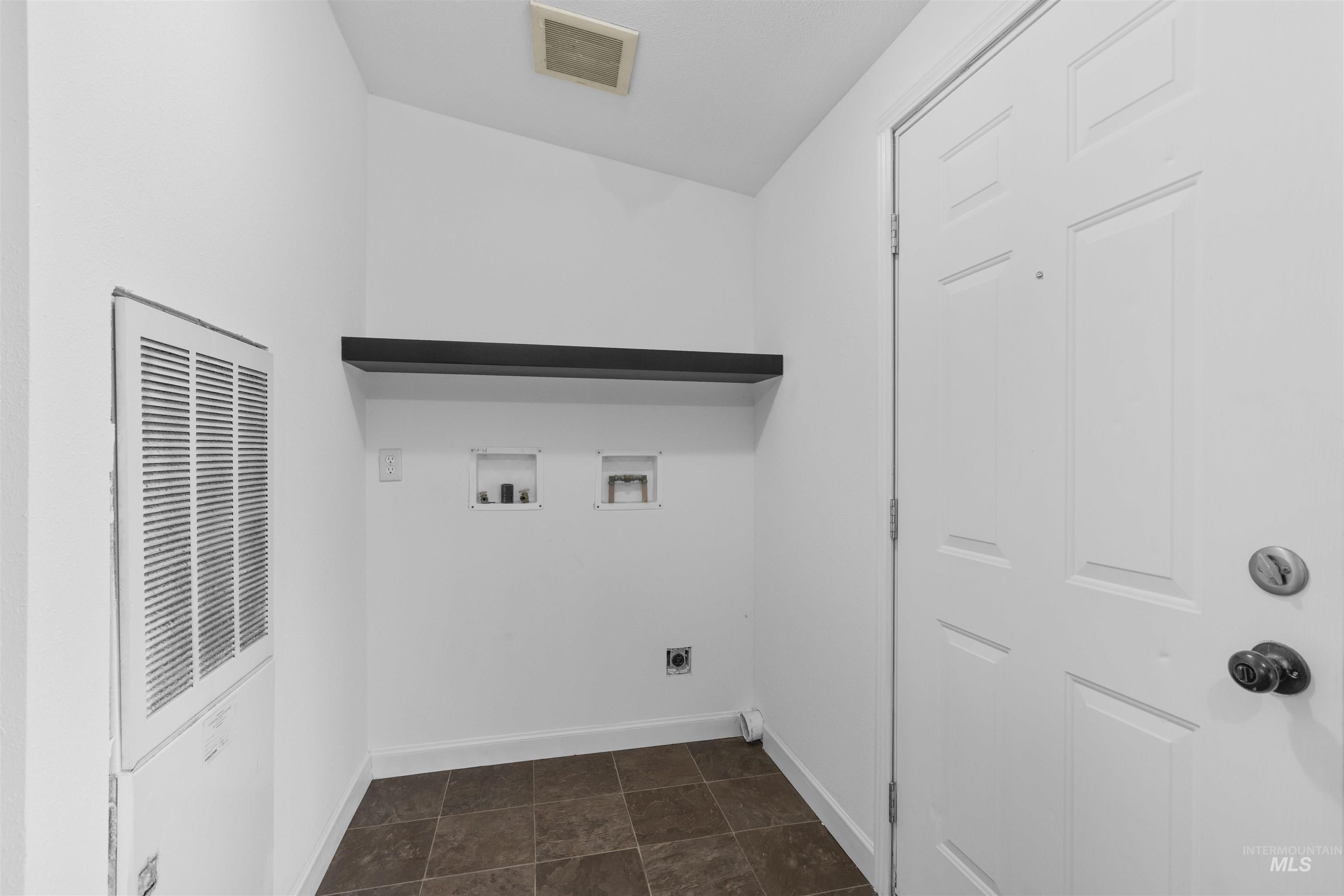 Laundry area featuring hookup for a washing machine, a heating unit, and hookup for an electric dryer