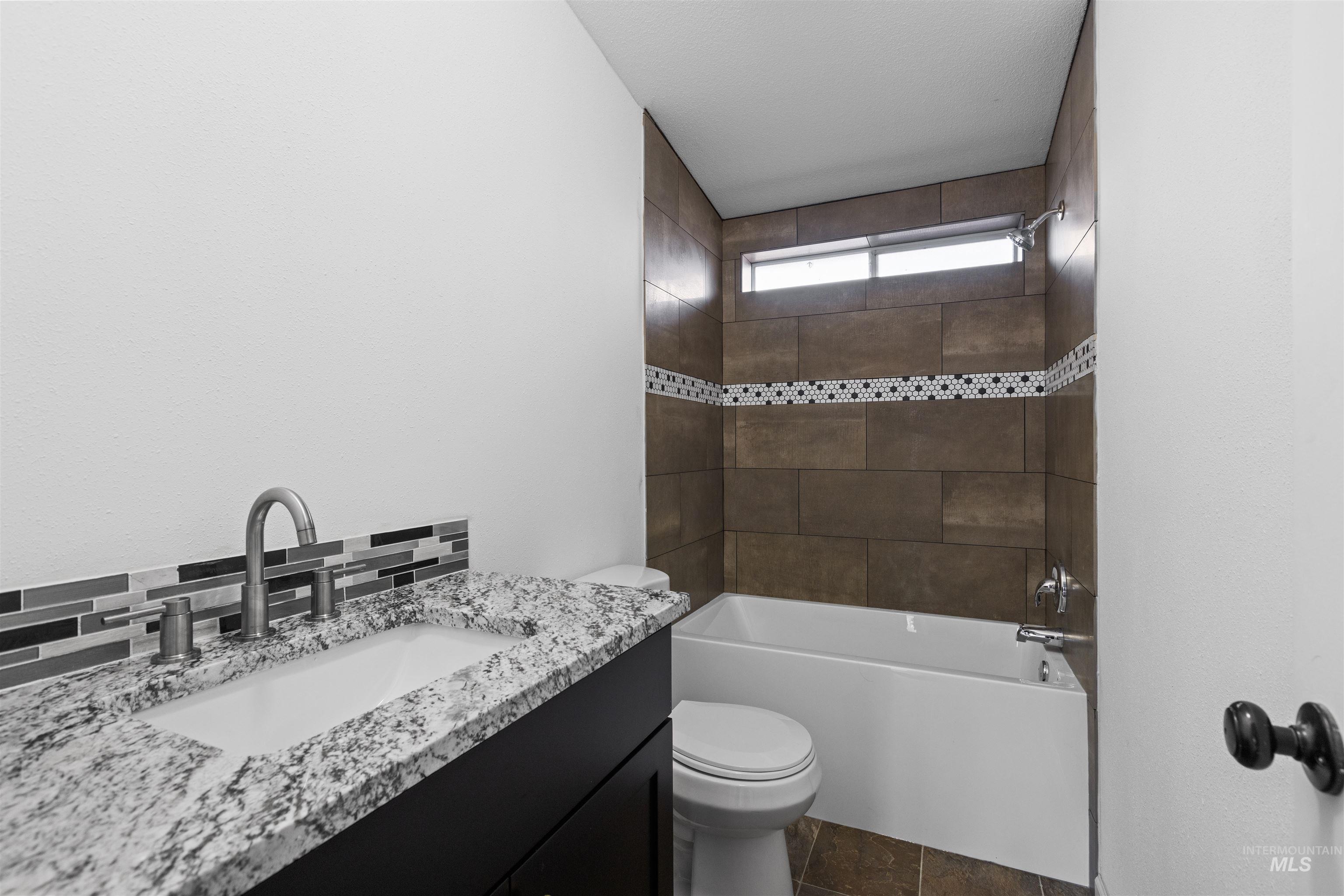 Bathroom with vanity and  shower combination