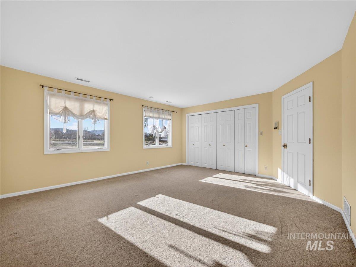 Unfurnished bedroom with a closet and carpet floors