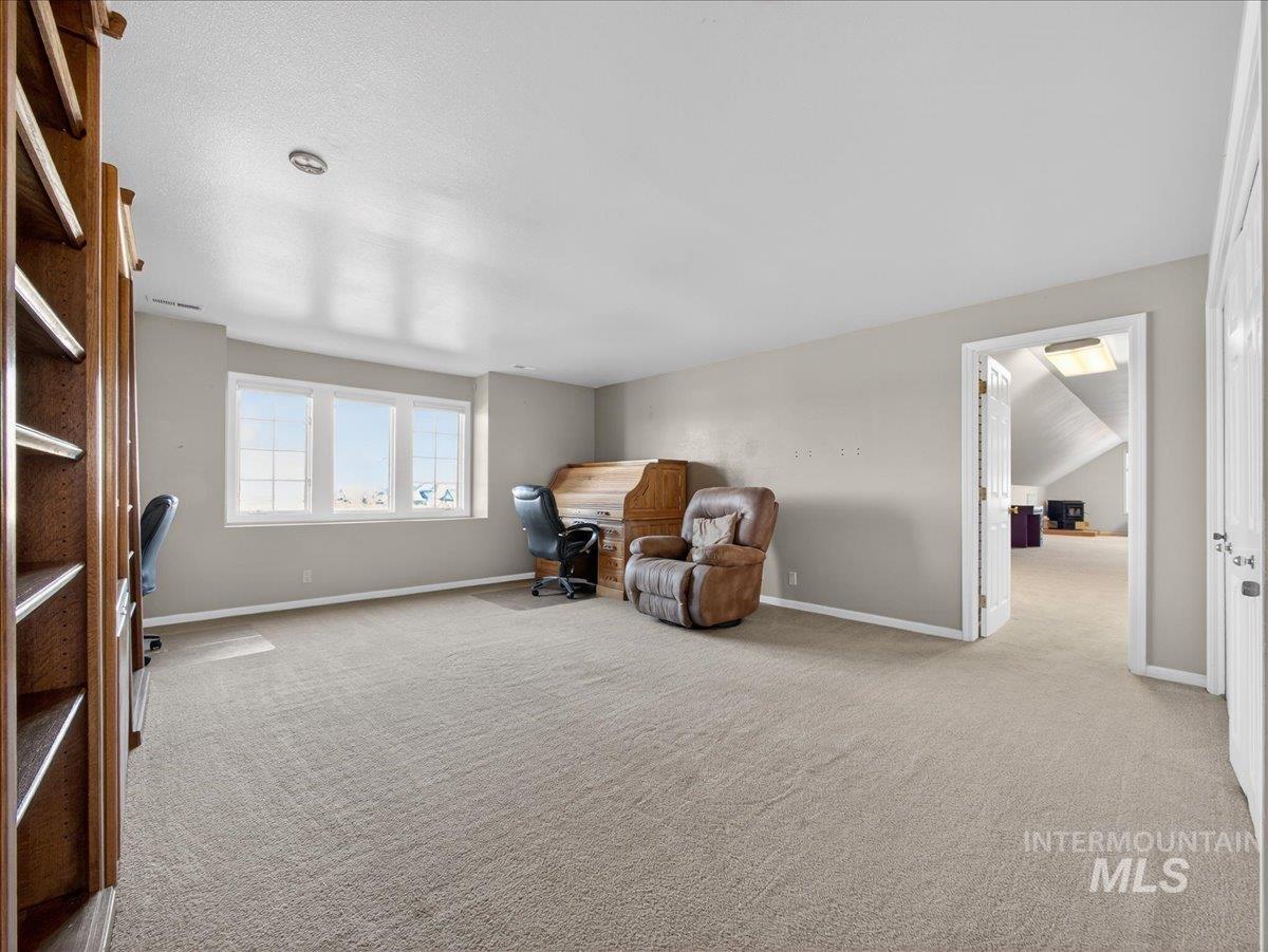 Unfurnished room featuring an office area and light colored carpet