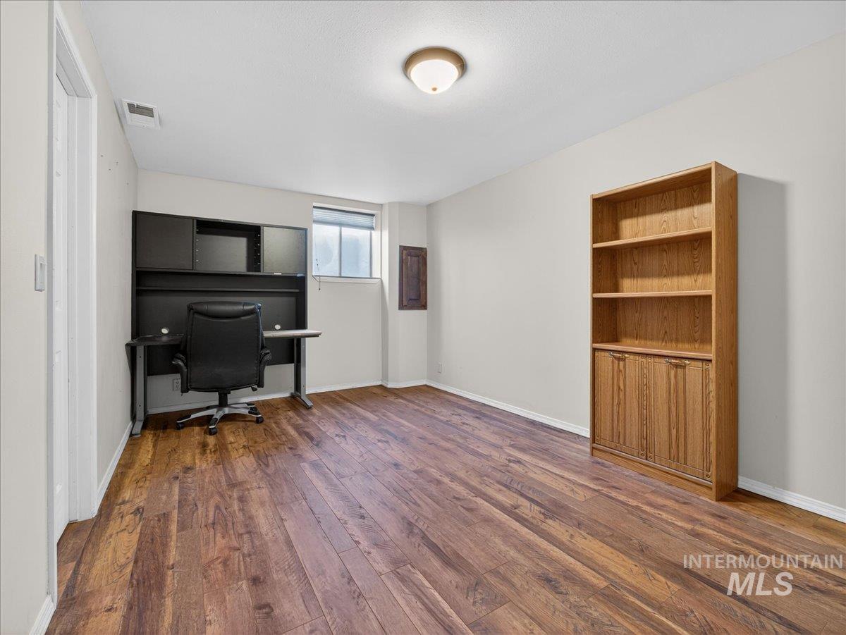 Office space with dark wood finished floors and baseboards
