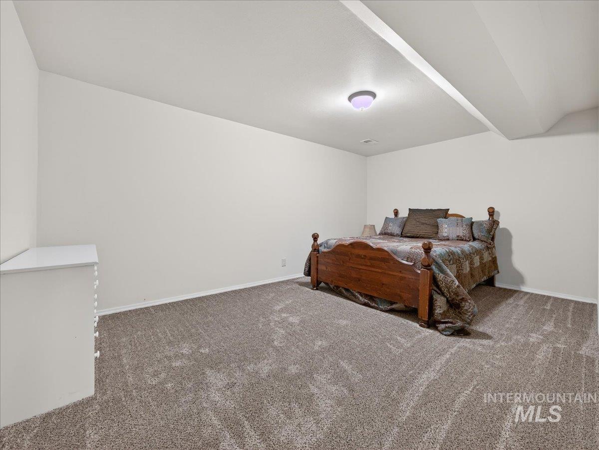 Carpeted bedroom featuring baseboards