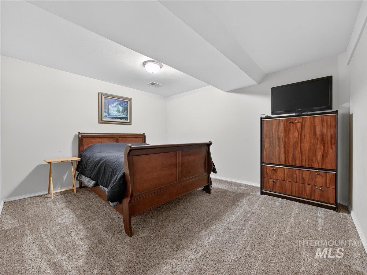 Carpeted bedroom with baseboards