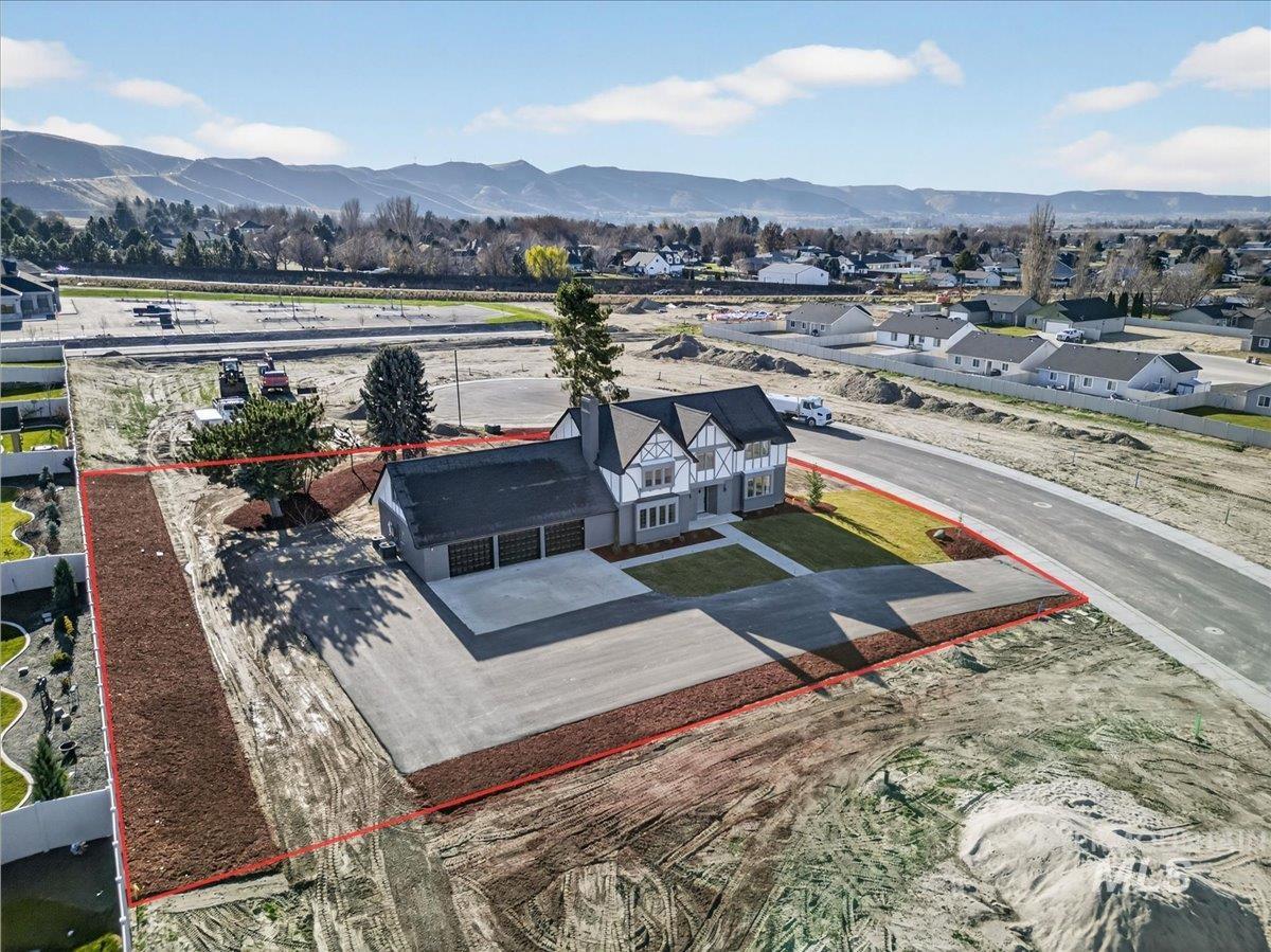 Aerial view of property and surrounding area featuring property boundaries highlighted and mountains