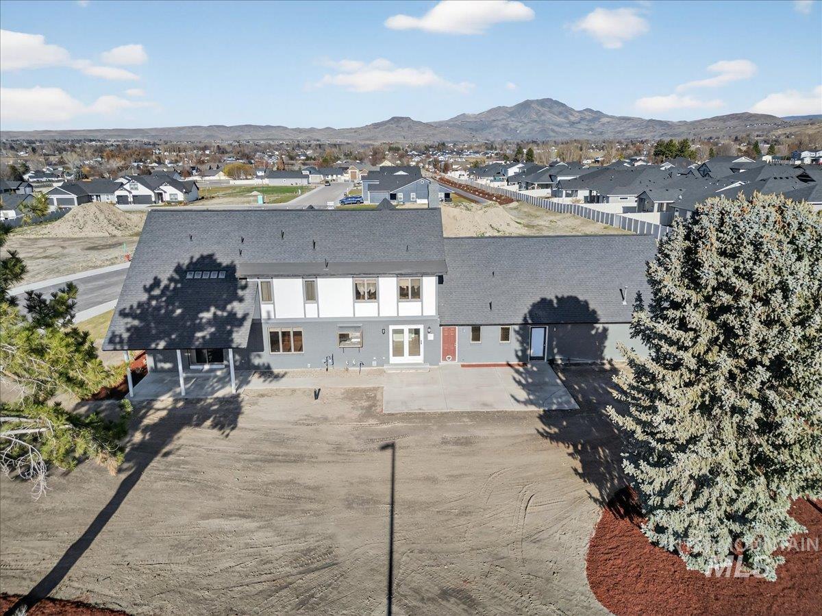 Aerial perspective of suburban area with a mountain backdrop