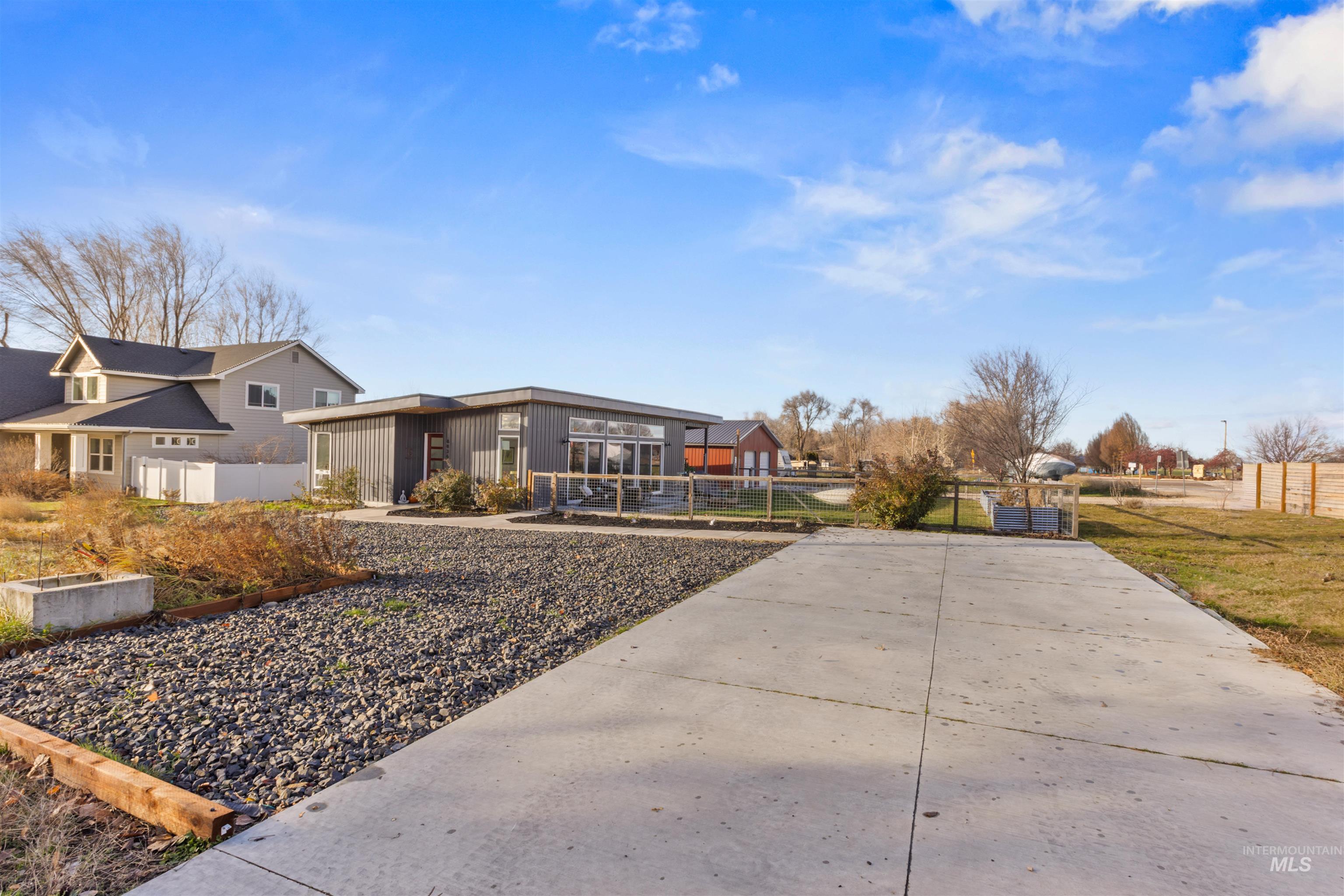 View of front of home with a fenced front yard and a residential view