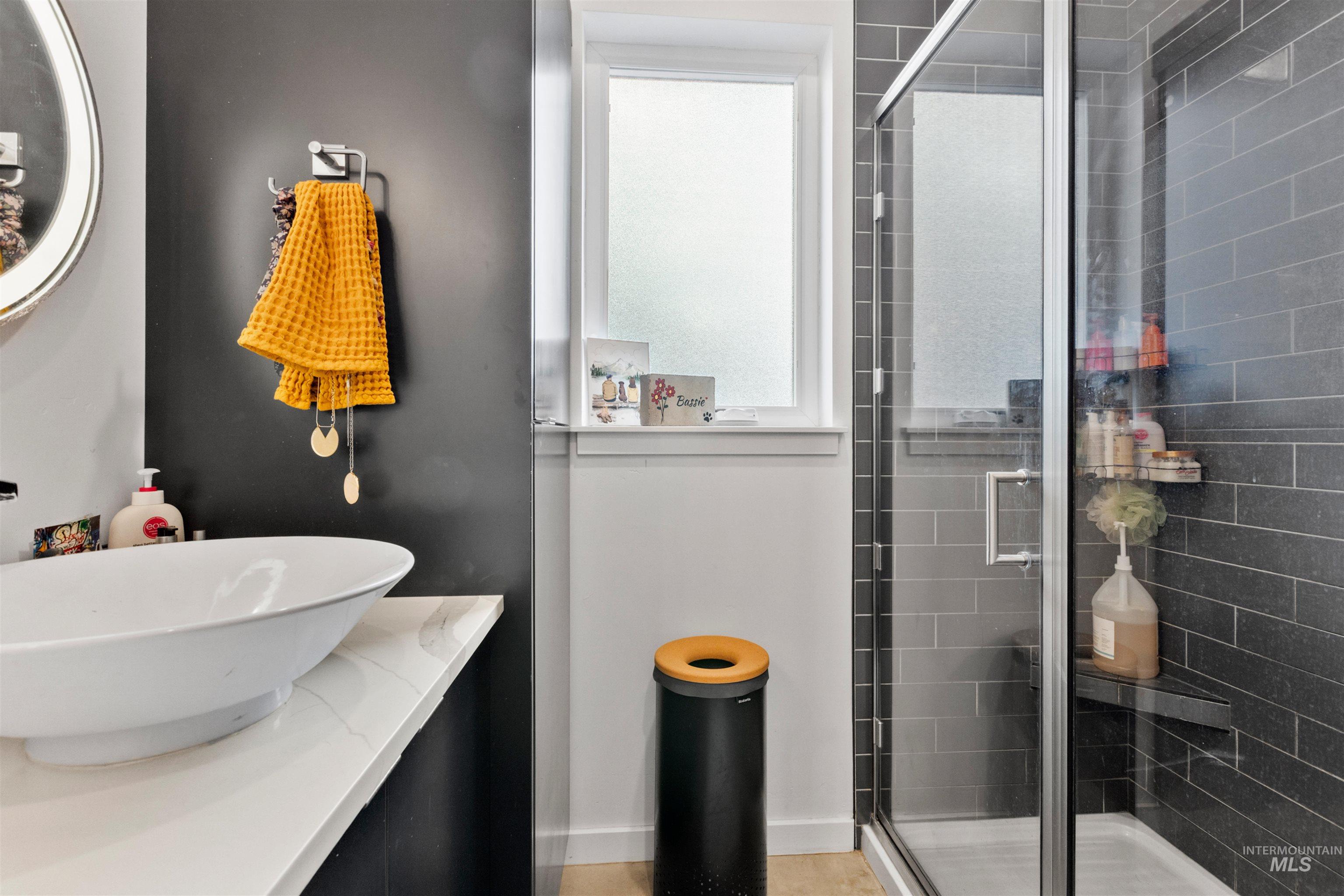 Full bath featuring vanity and a shower stall