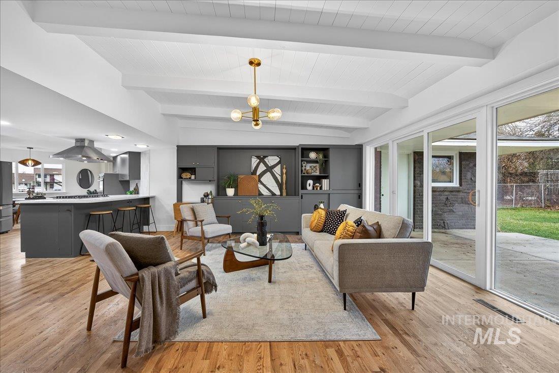 Living area with a chandelier and light wood-style flooring