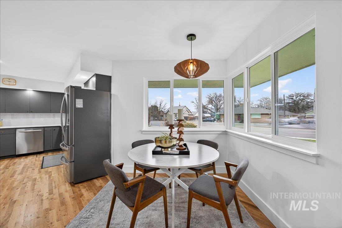 Dining room with light wood finished floors and baseboards