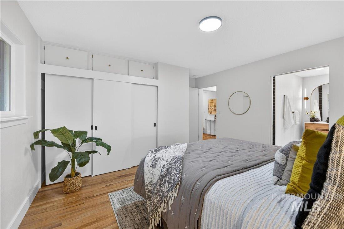Bedroom with wood finished floors and a closet