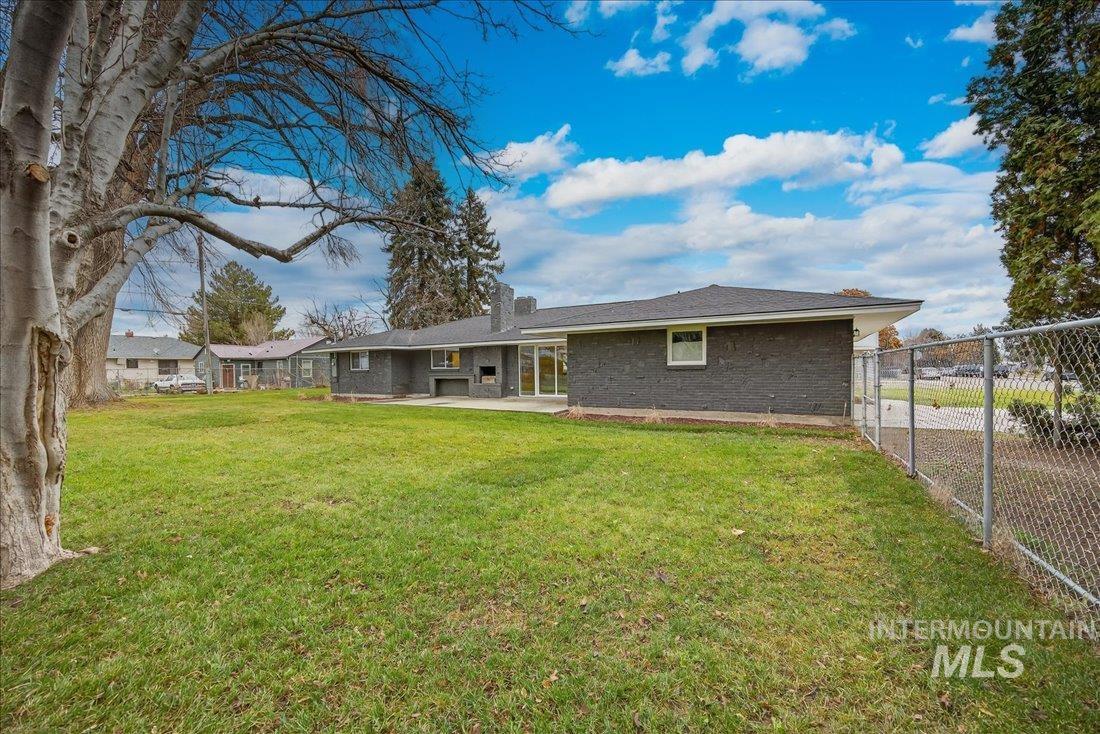 Back of house with brick siding and a patio