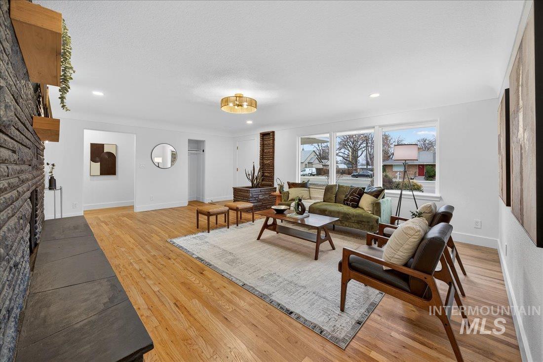 Living room featuring light wood finished floors and recessed lighting