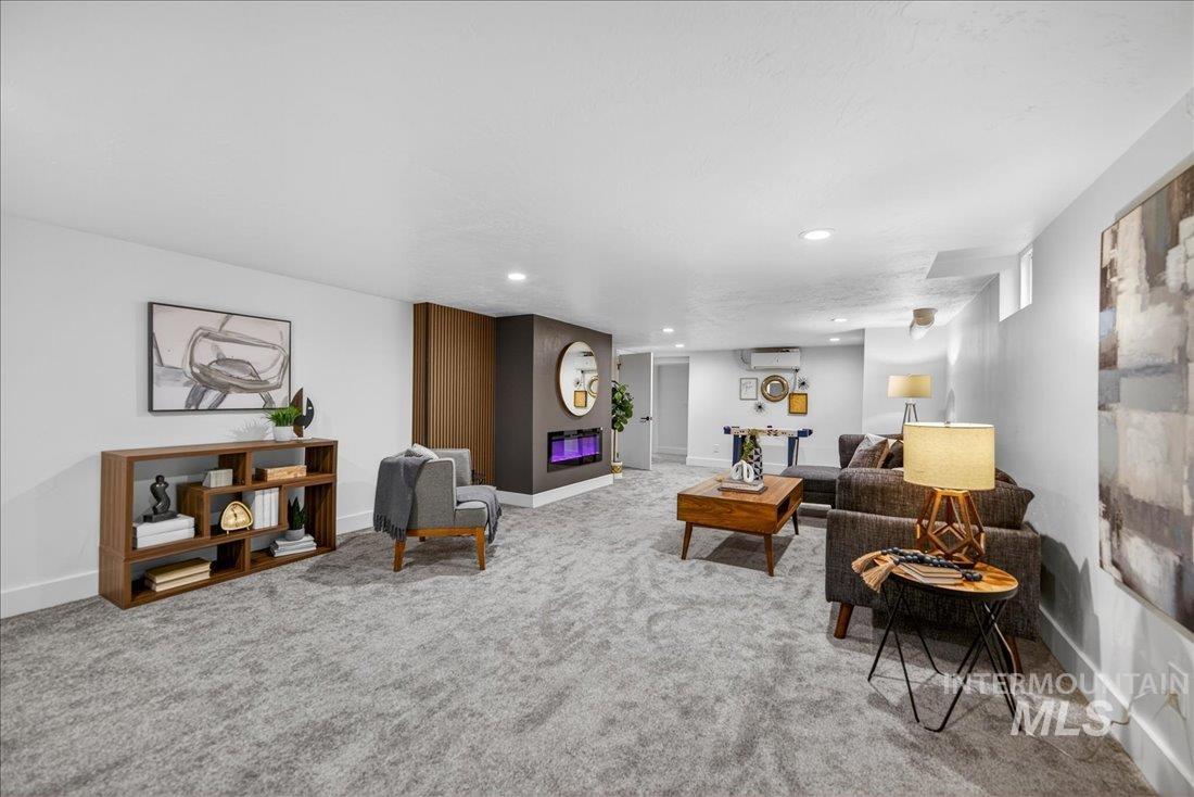 Living area with light carpet and recessed lighting