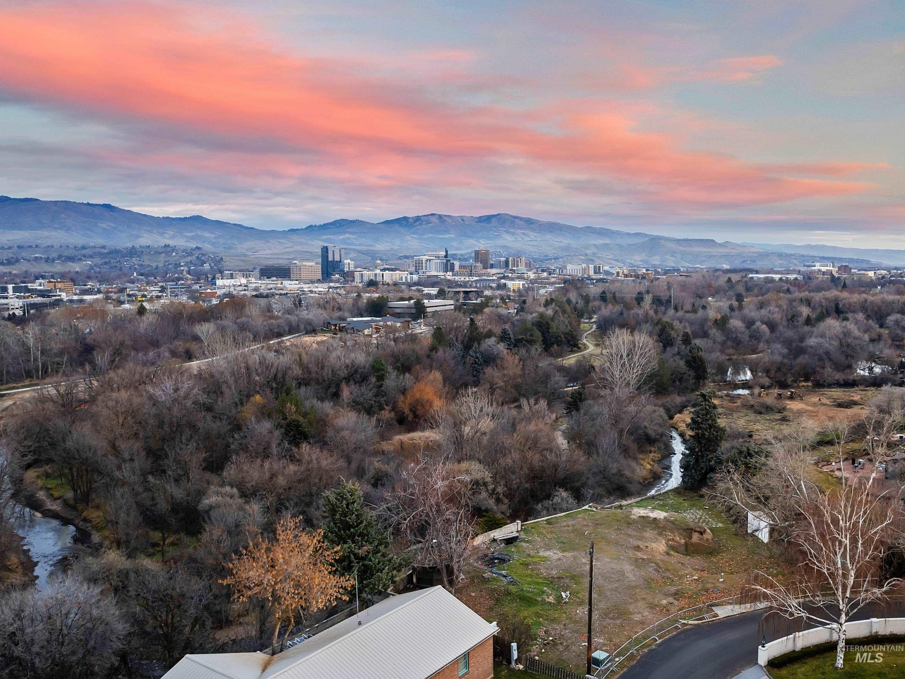 Aerial view of property and surrounding area with a mountainous background