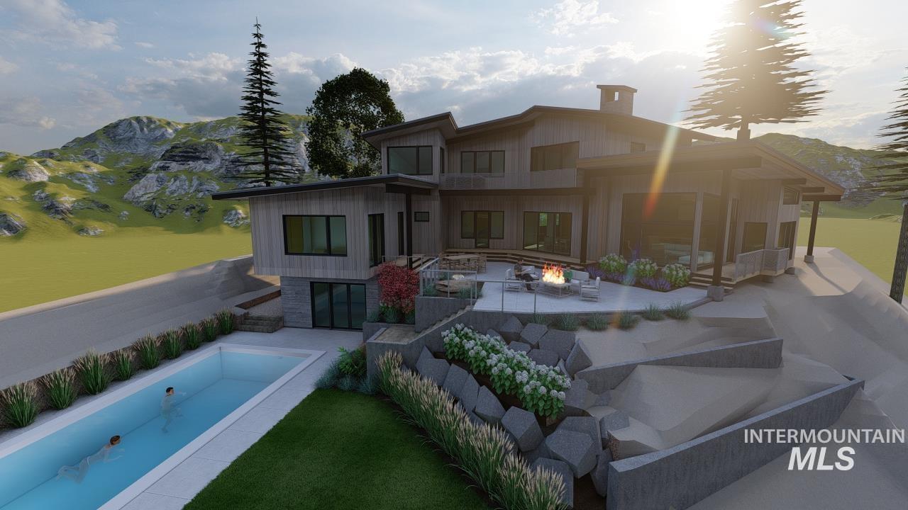 Rear view of house with a fire pit, a patio, a mountain view, and board and batten siding