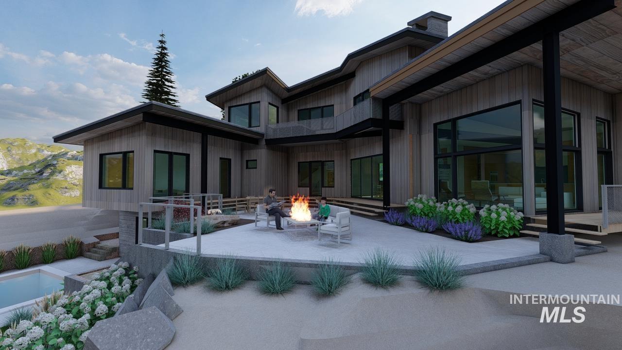 Back of property with a patio, a fire pit, board and batten siding, and a chimney