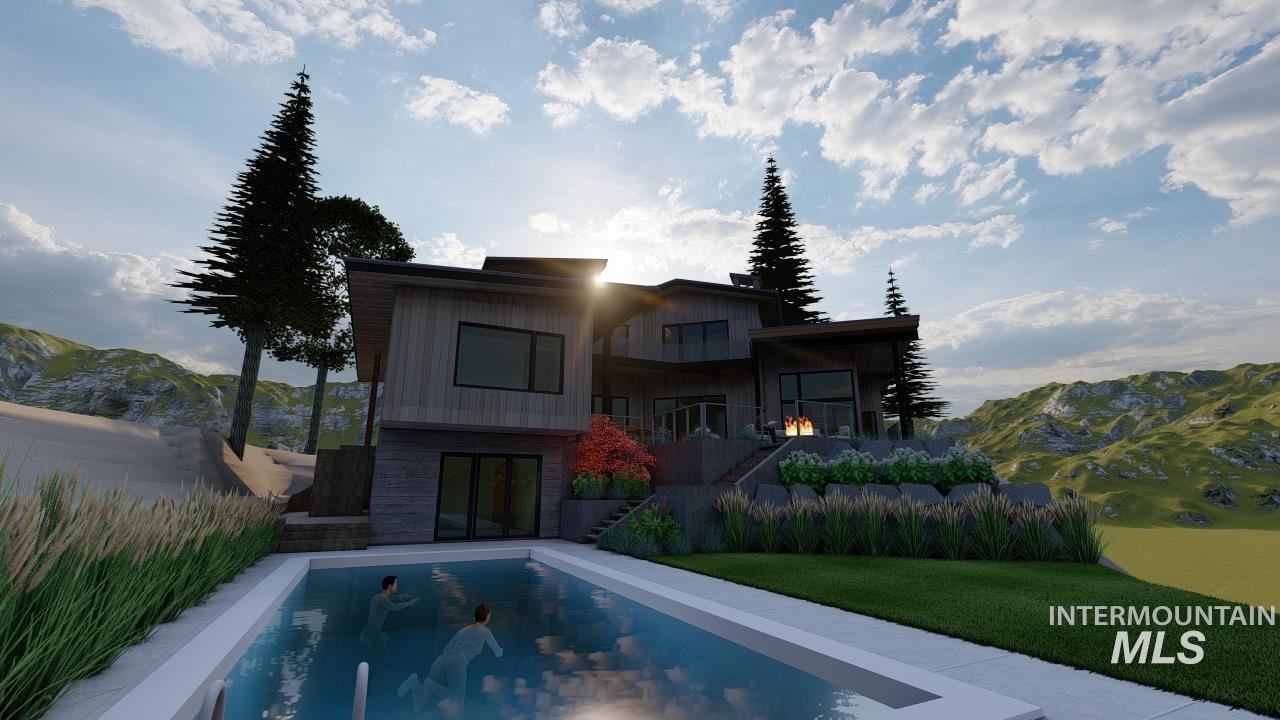 Back of property with stairway, a mountain view, a balcony, and a lawn