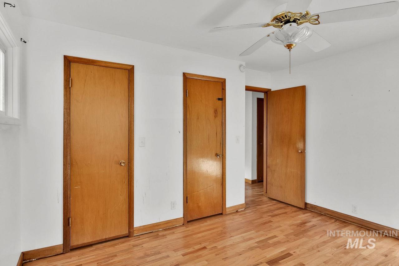 Unfurnished bedroom with light wood-type flooring and a ceiling fan