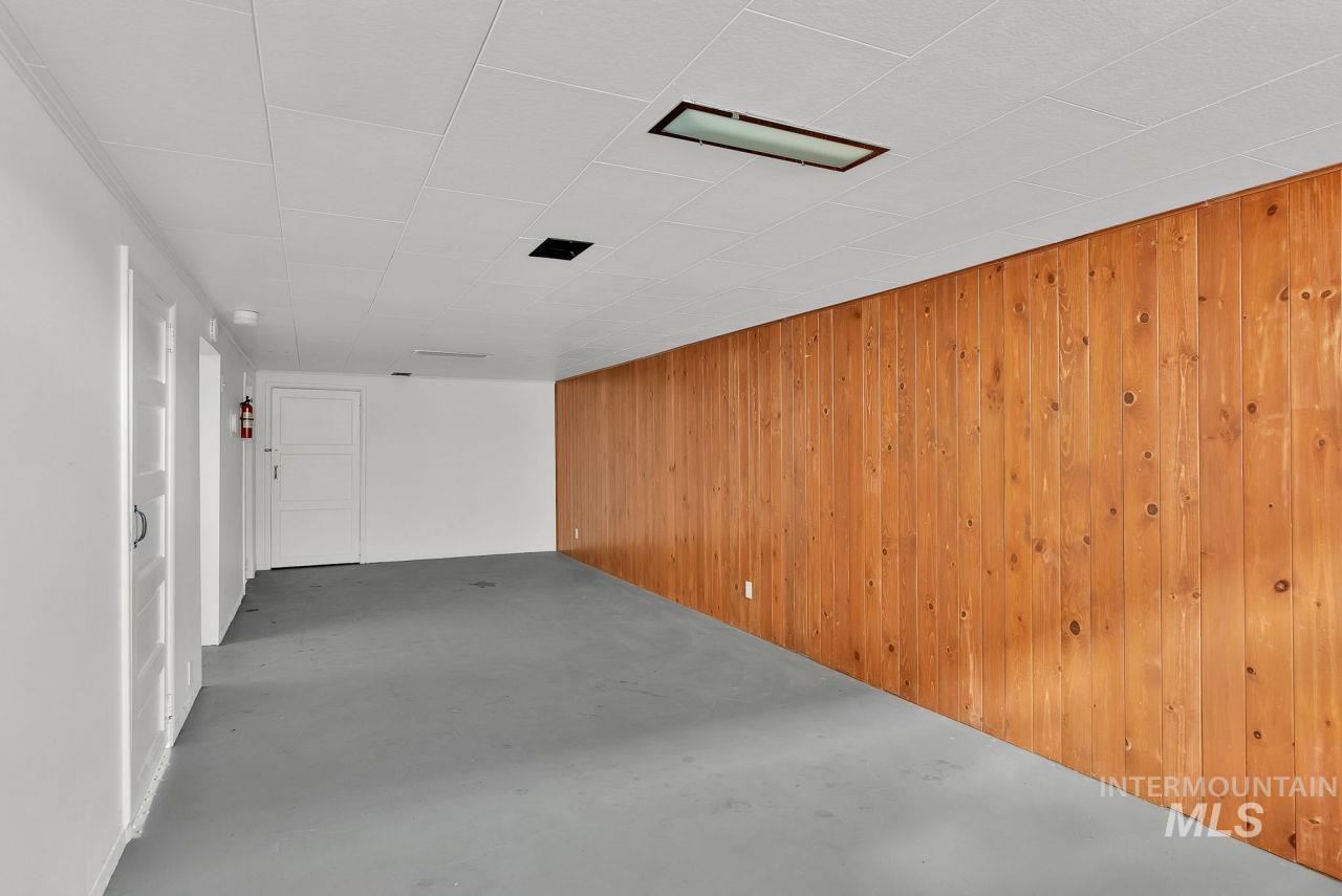 Basement featuring wood walls