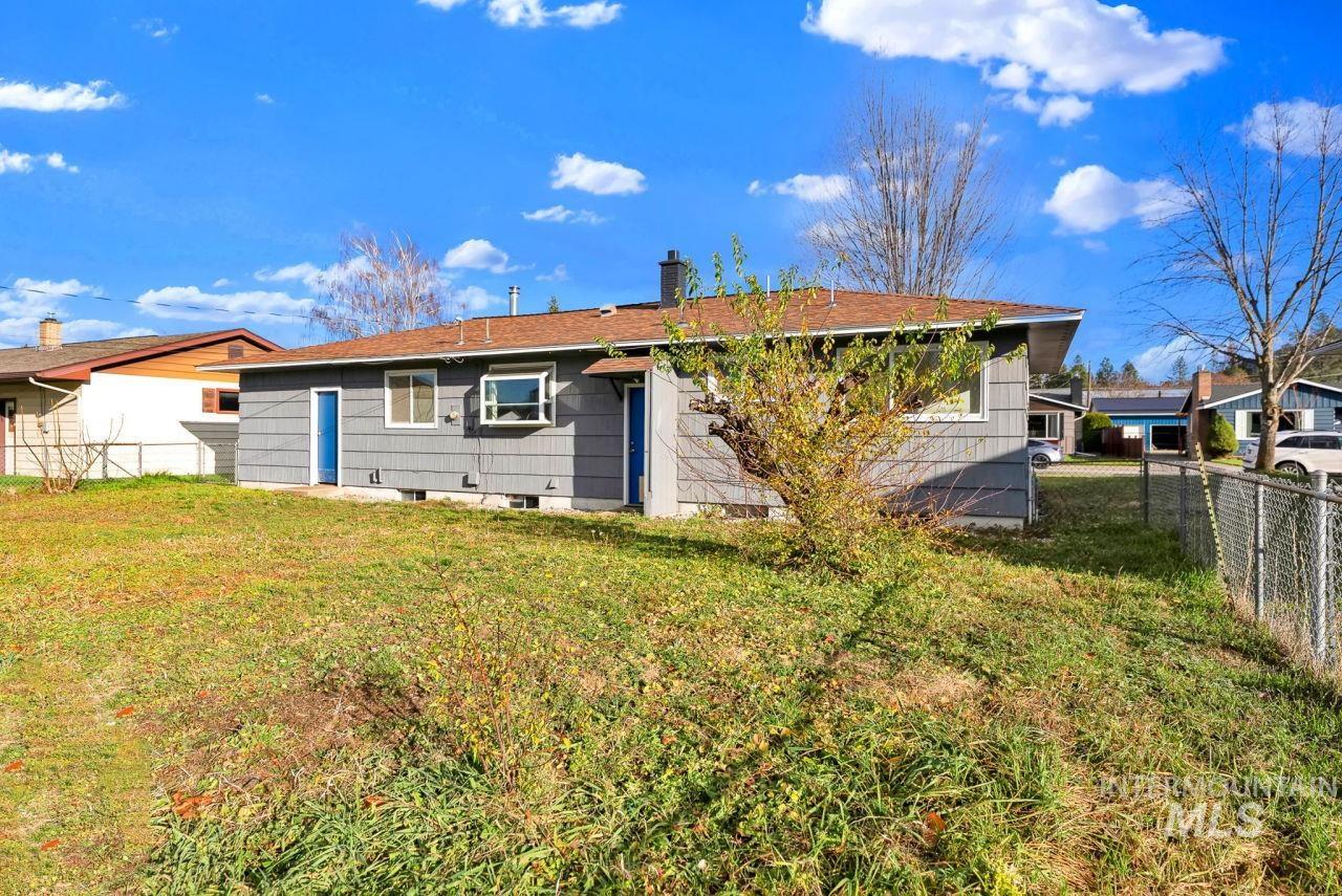 Rear view of property featuring a chimney