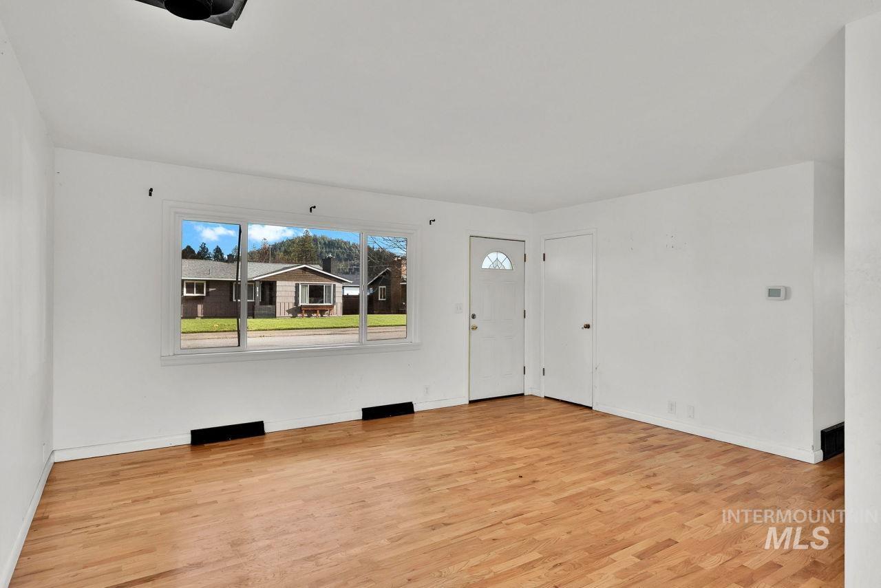 Entrance foyer with healthy amount of natural light and light wood-style flooring