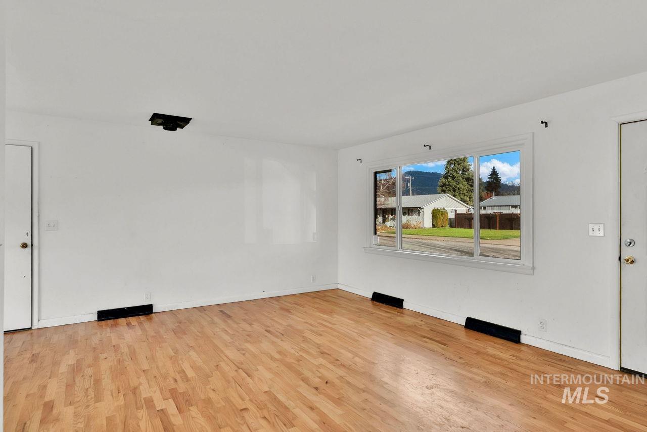 Spare room with light wood-type flooring and baseboards