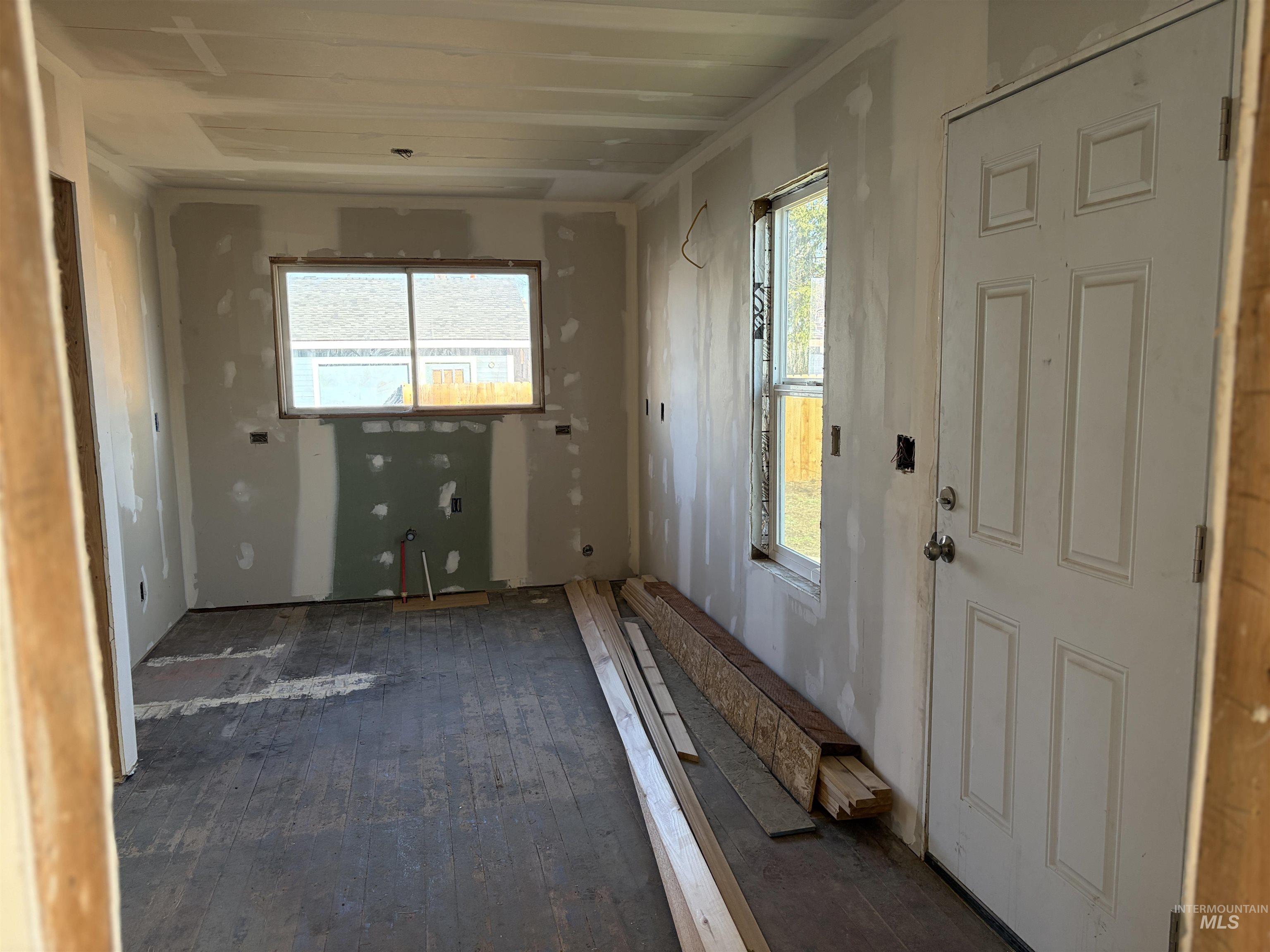 Foyer featuring healthy amount of natural light and dark wood-style flooring