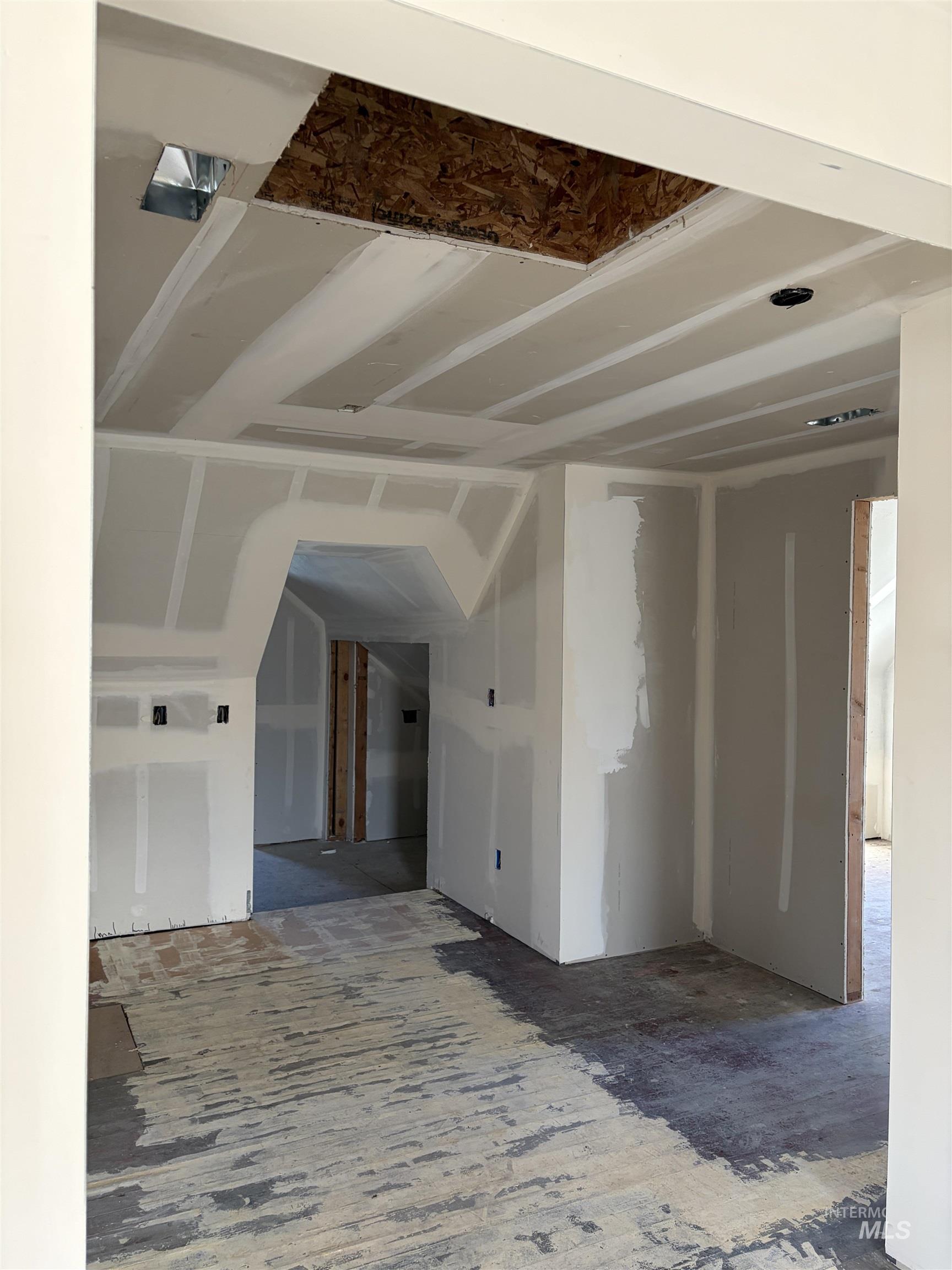 Empty room with vaulted ceiling