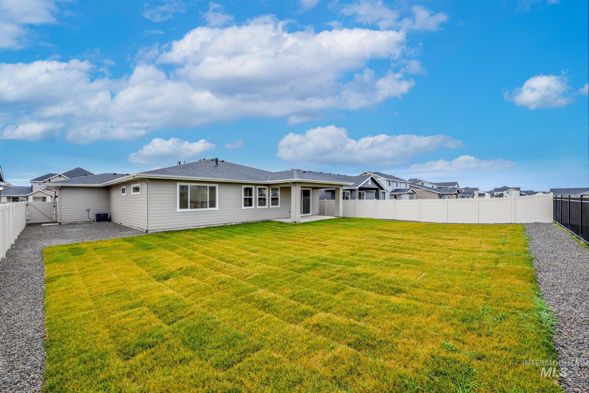 Rear view of house with a patio and a fenced backyard