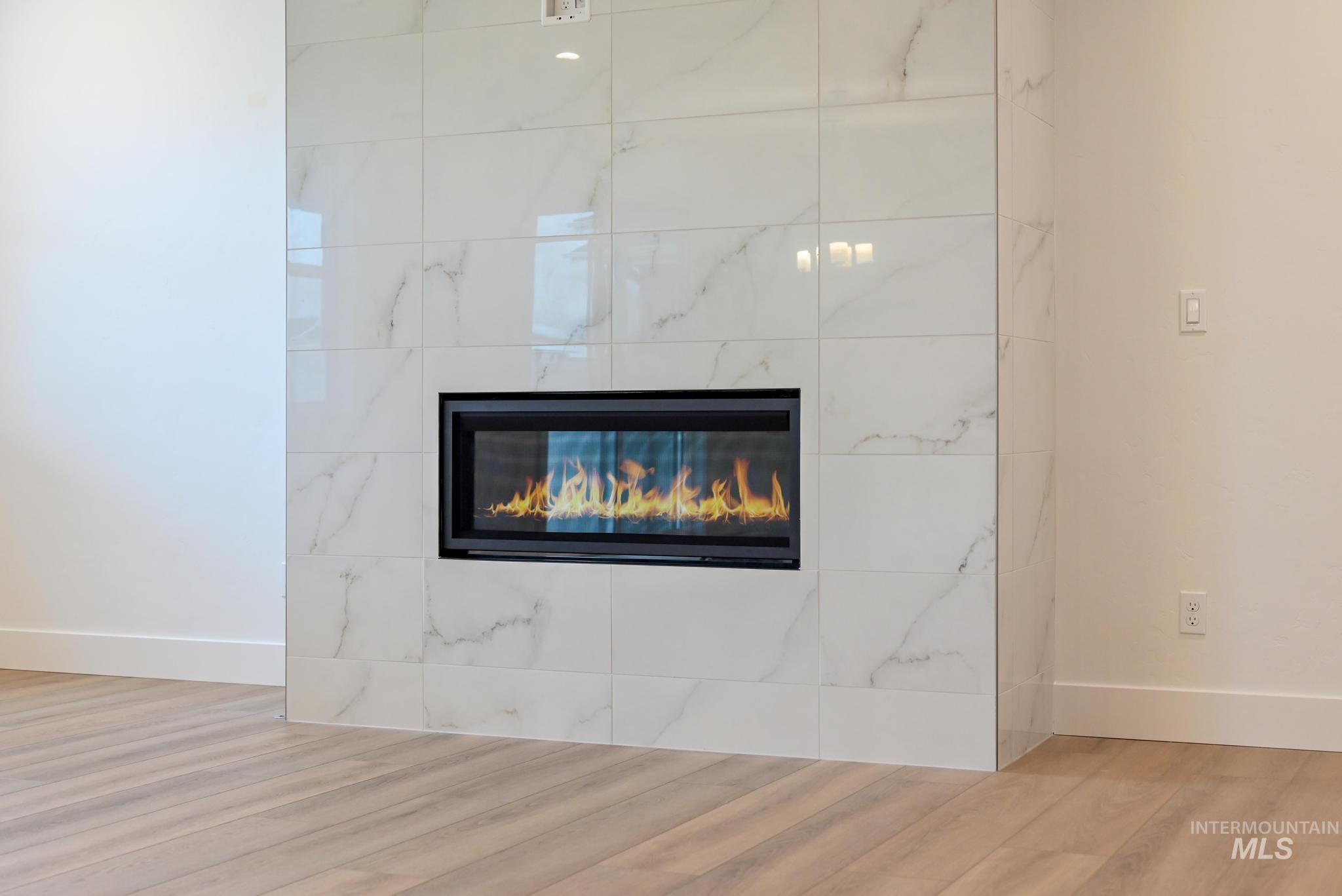 Detailed view of a fireplace and wood finished floors