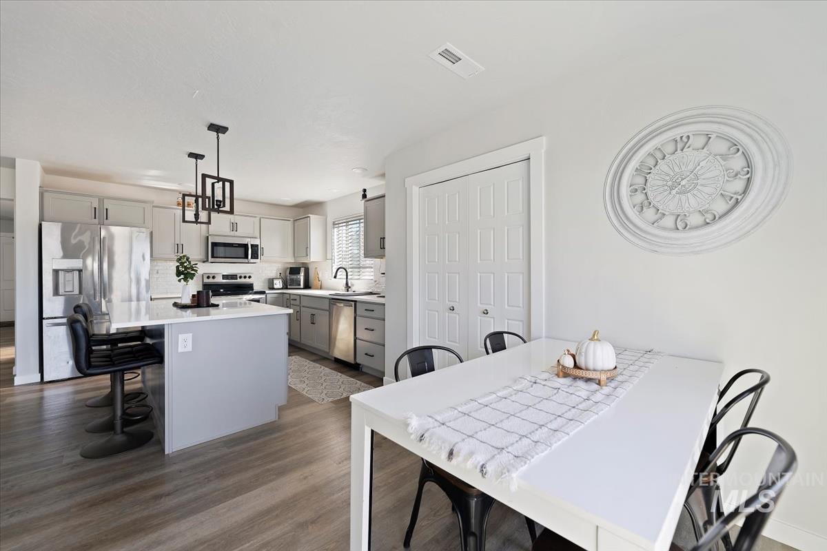 Dining area with dark wood-style flooring