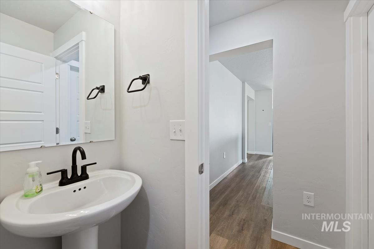 Bathroom with dark wood-type flooring and a sink