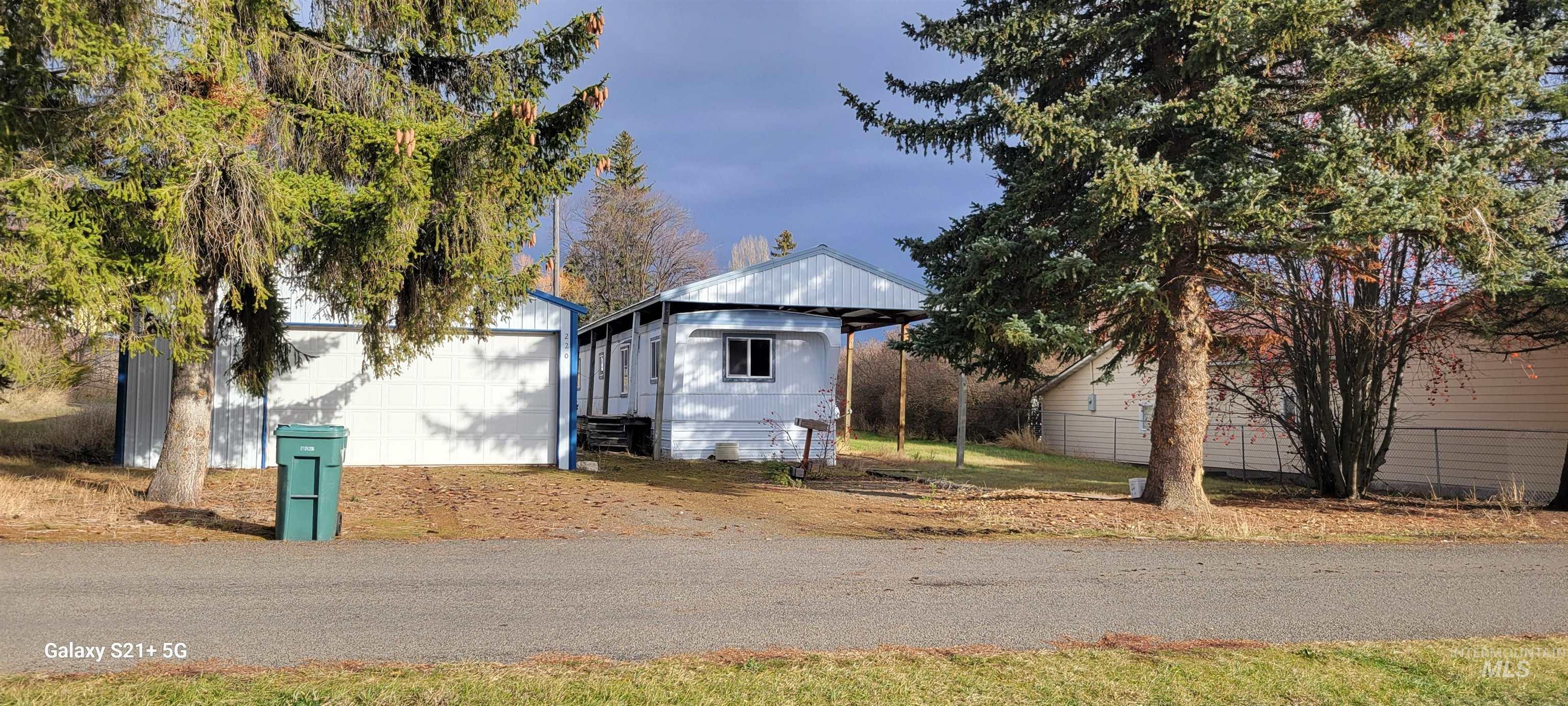 View of home's exterior with an outbuilding and a detached garage