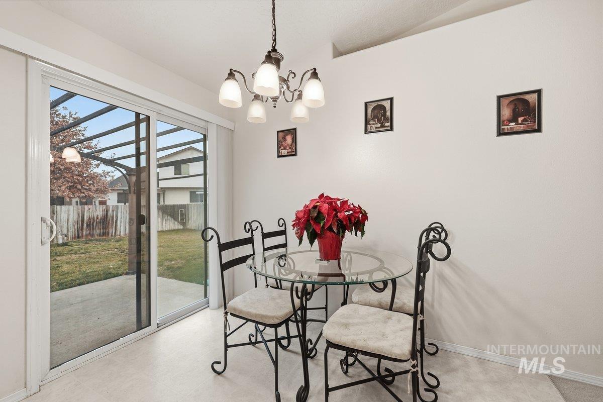 Dining space featuring a chandelier and light flooring