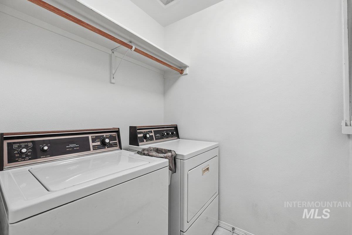 Laundry area with washing machine and clothes dryer
