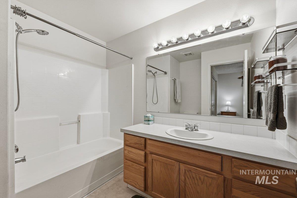 Bathroom featuring vanity and tub / shower combination