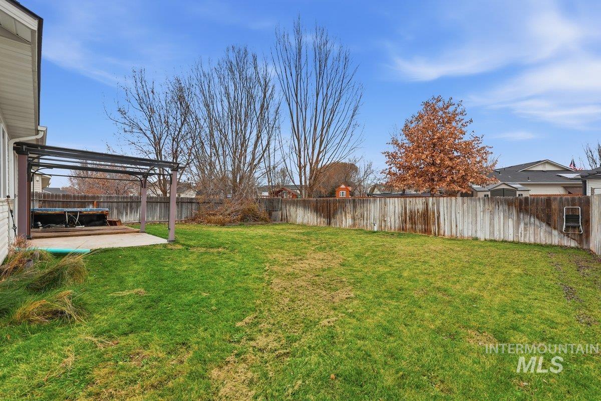 Fenced backyard with a patio and a pergola