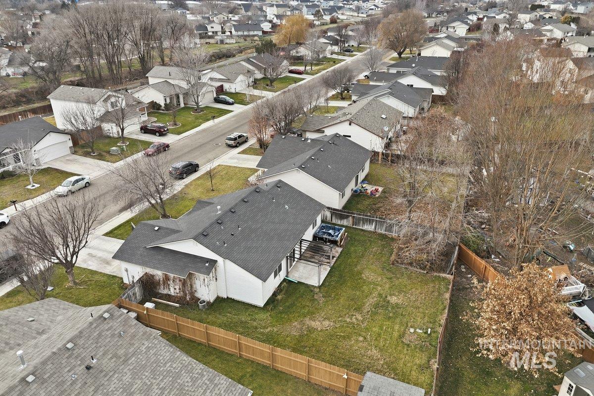 Aerial view of property and surrounding area featuring nearby suburban area