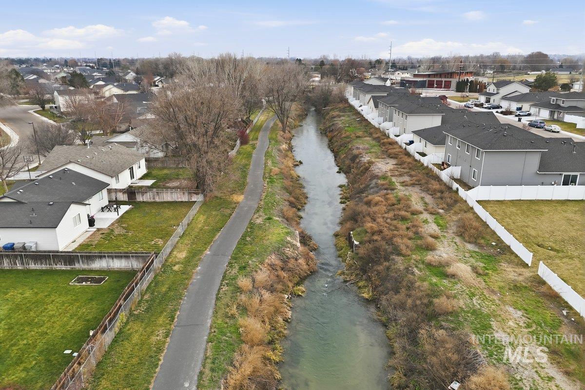 Aerial view of residential area featuring a nearby body of water