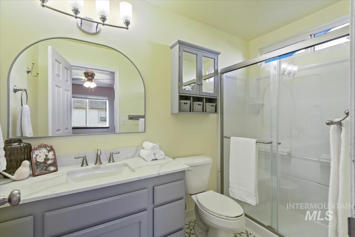 Bathroom with vanity and a stall shower