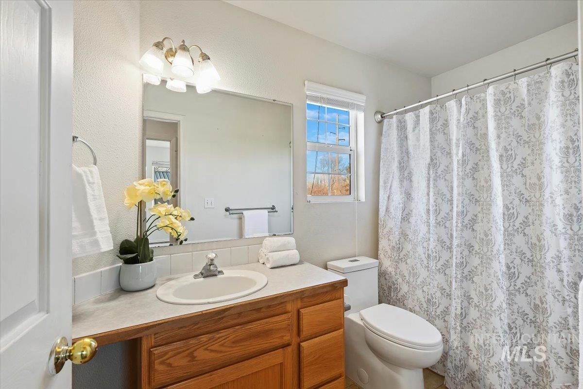 Full bathroom featuring vanity and curtained shower