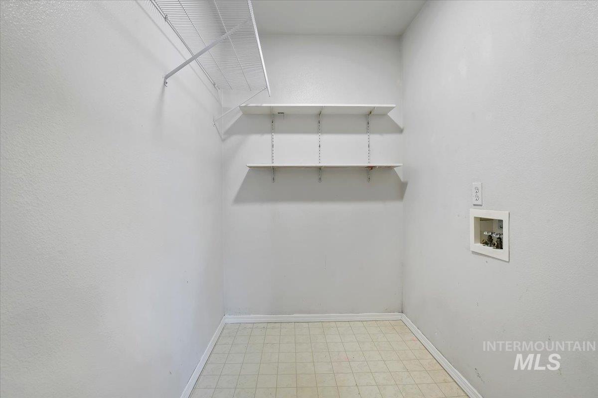Washroom featuring light flooring and washer hookup