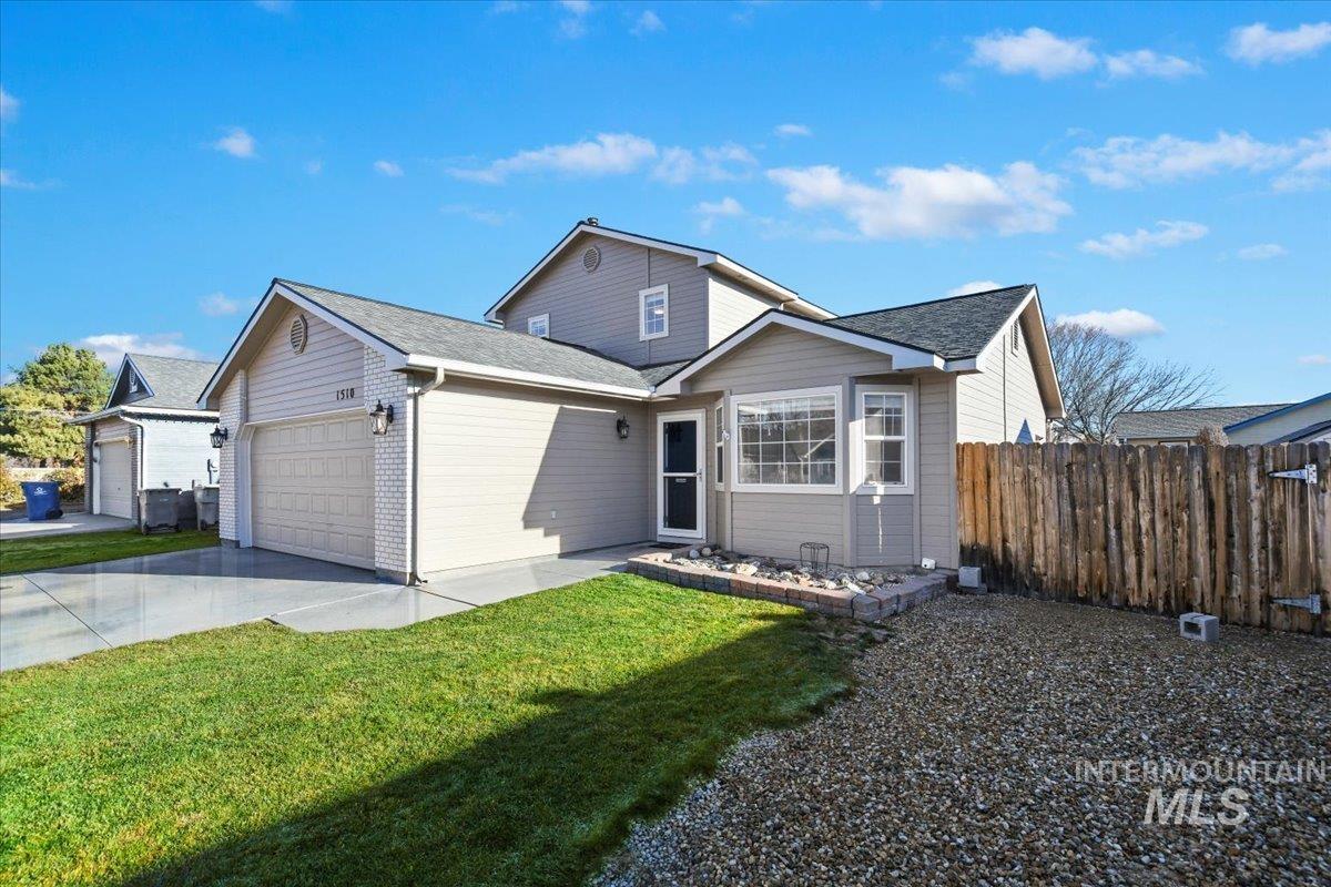 View of front of property with driveway, a garage, and a shingled roof