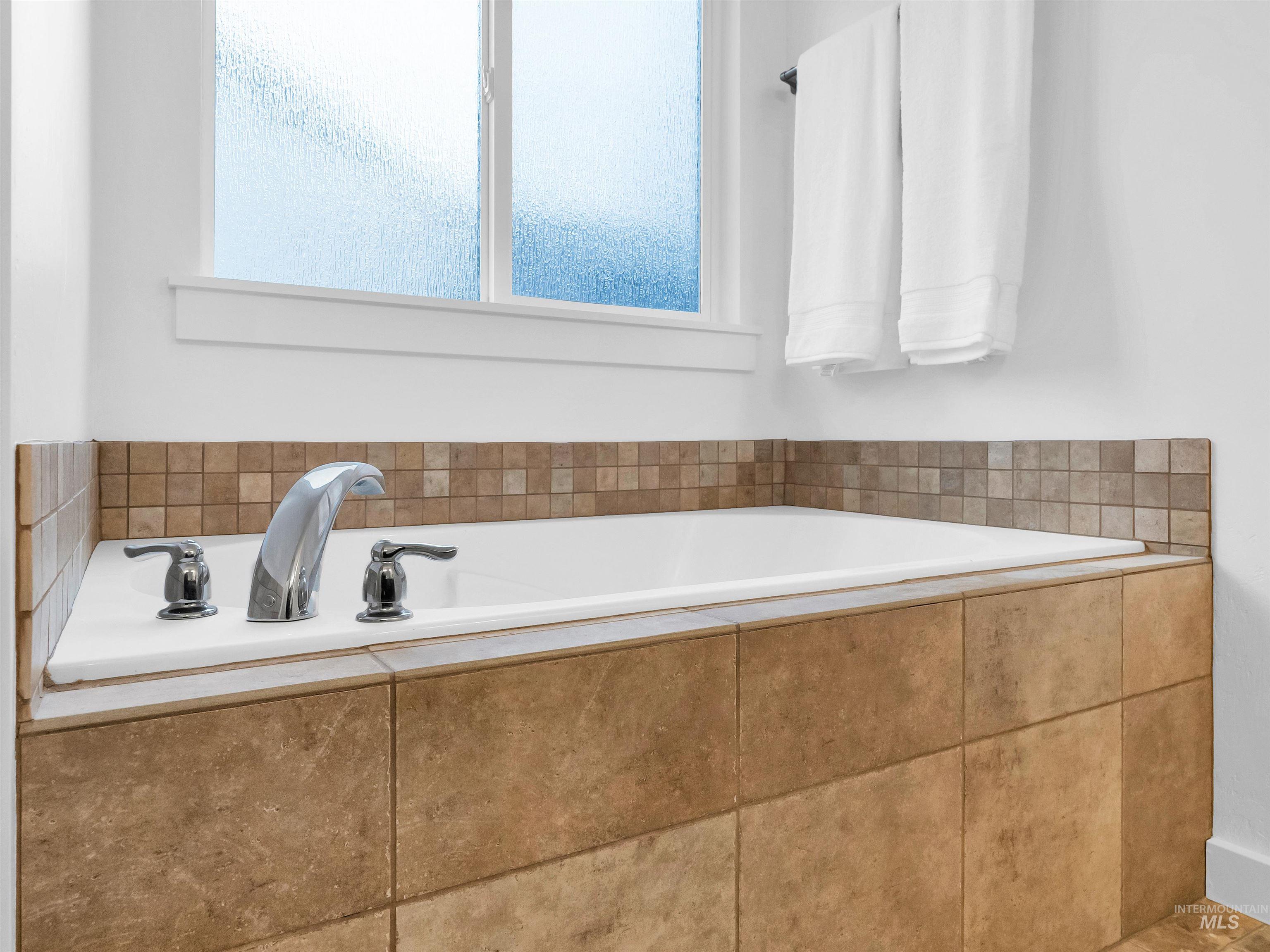 Bathroom featuring a bath and plenty of natural light