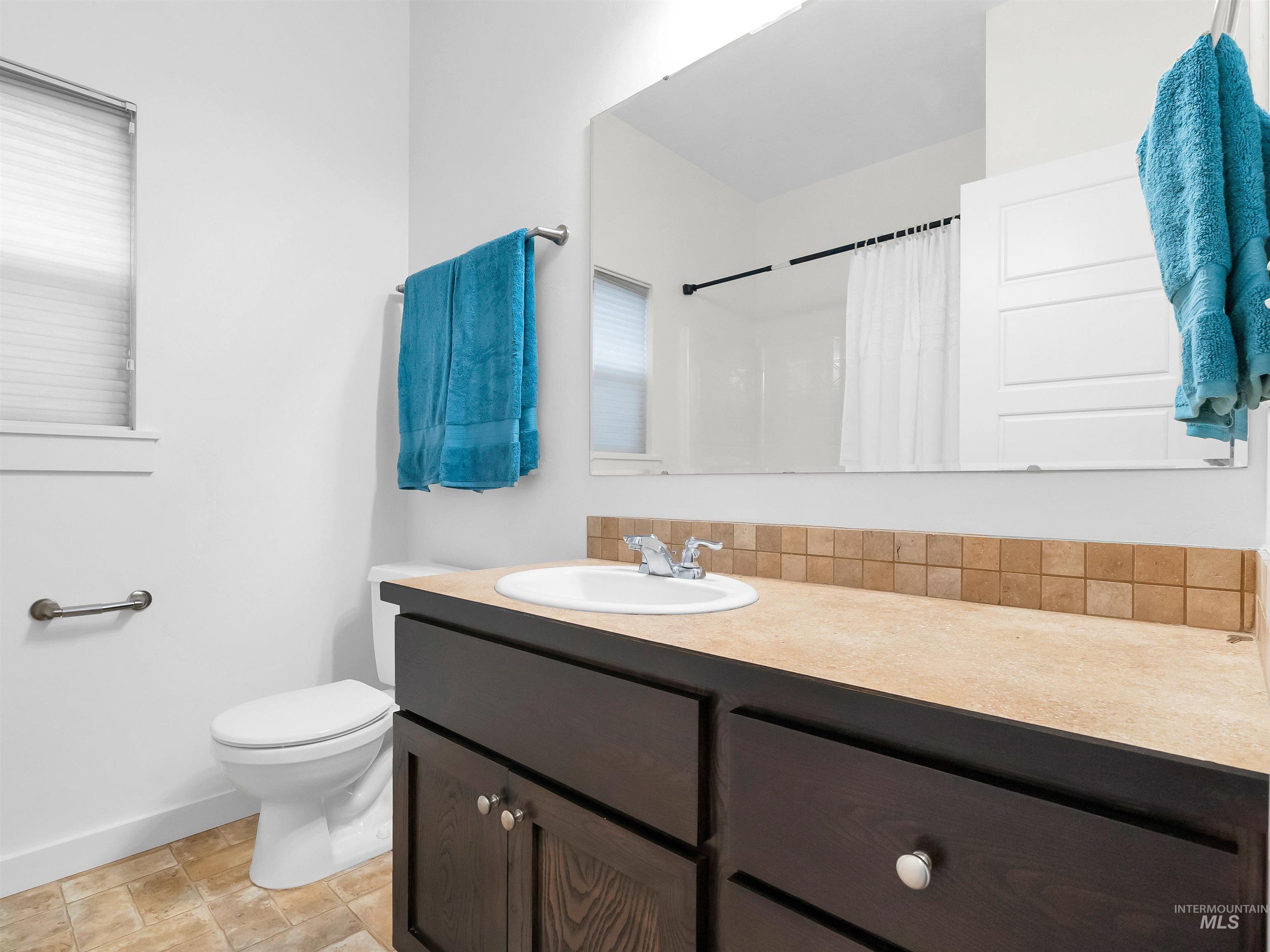 Full bath featuring a shower with curtain and vanity