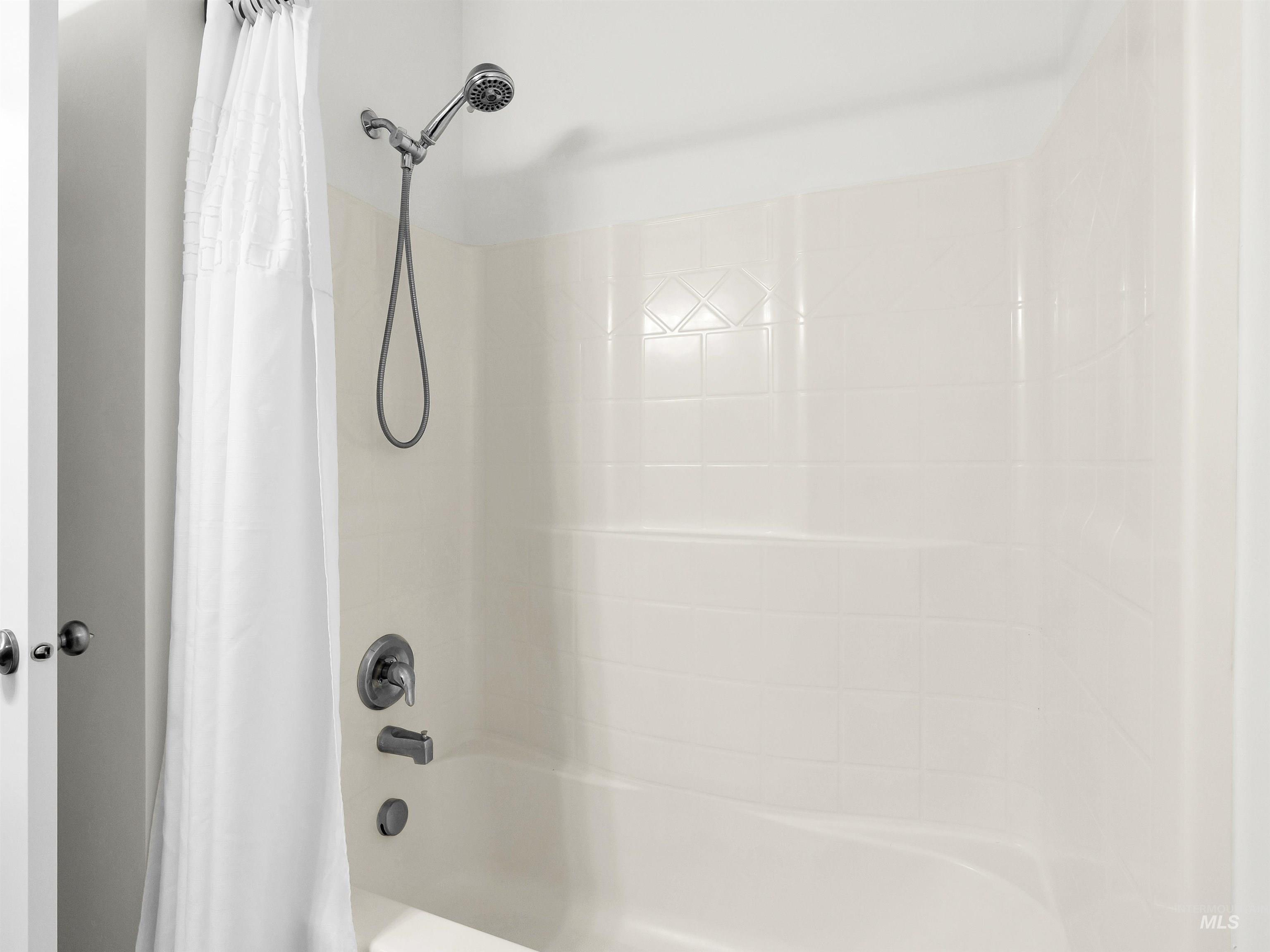 Bathroom with shower / bath combo with shower curtain