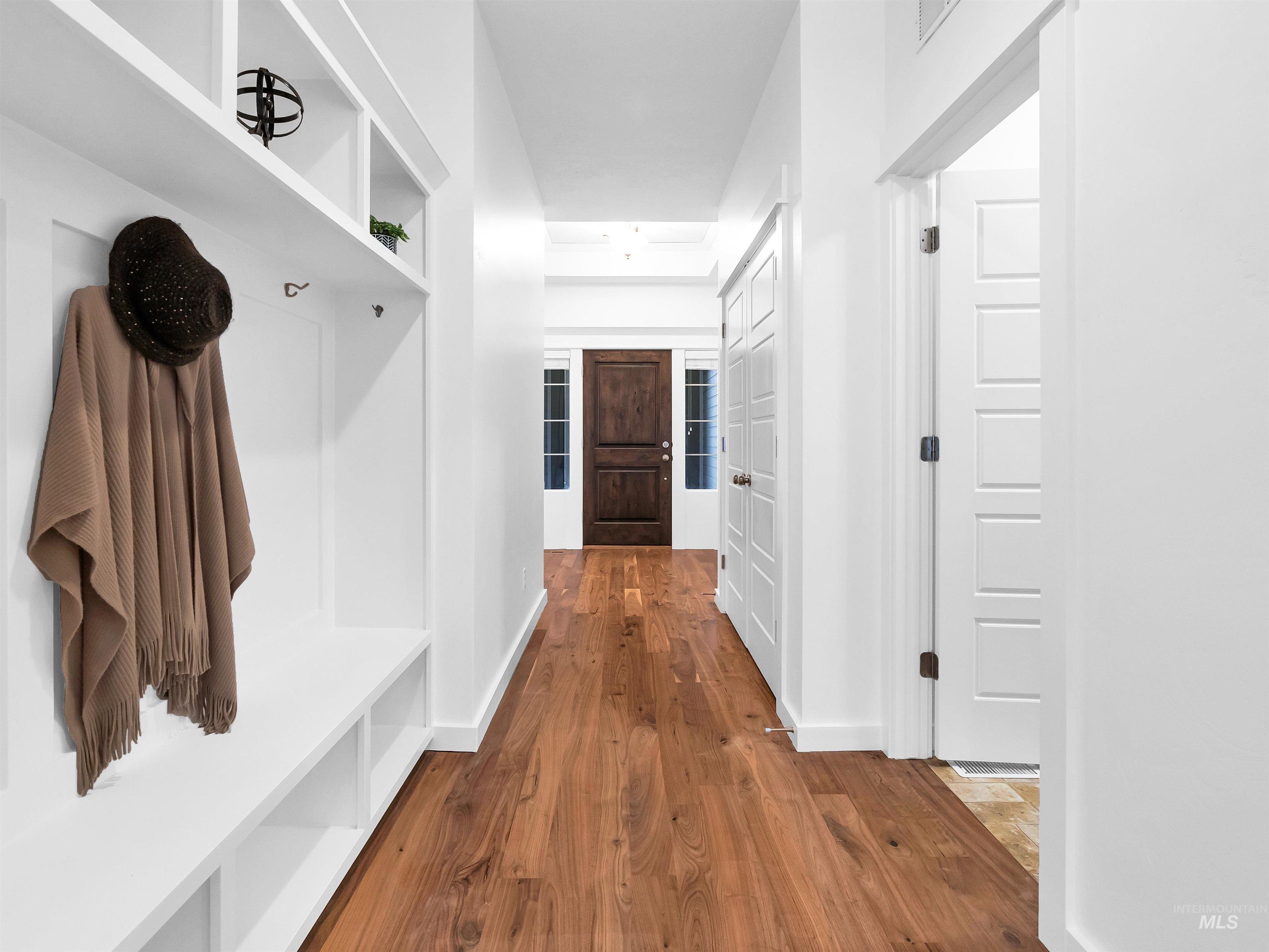 Mudroom featuring dark wood finished floors and baseboards