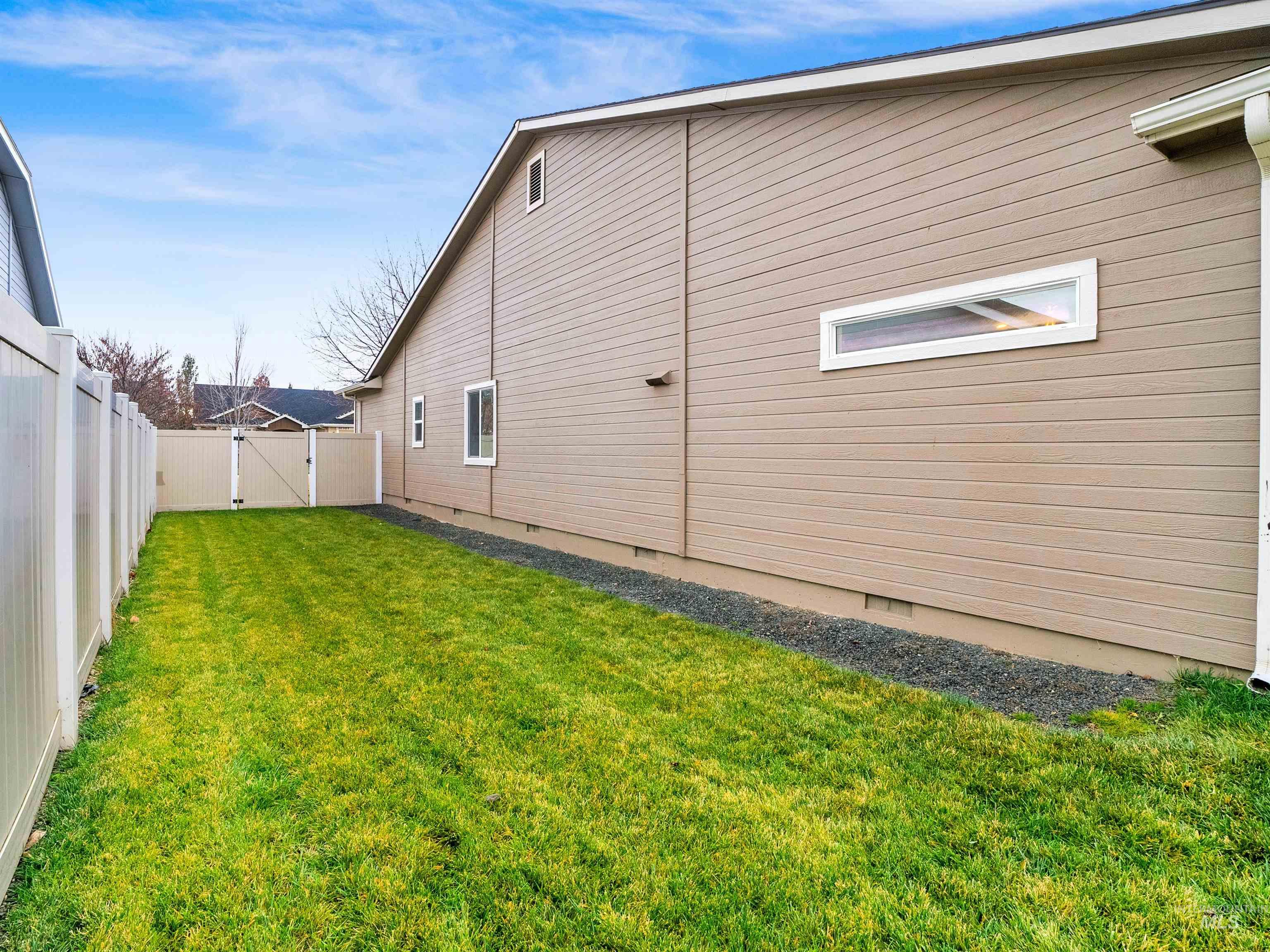 View of home's exterior featuring crawl space and a fenced backyard