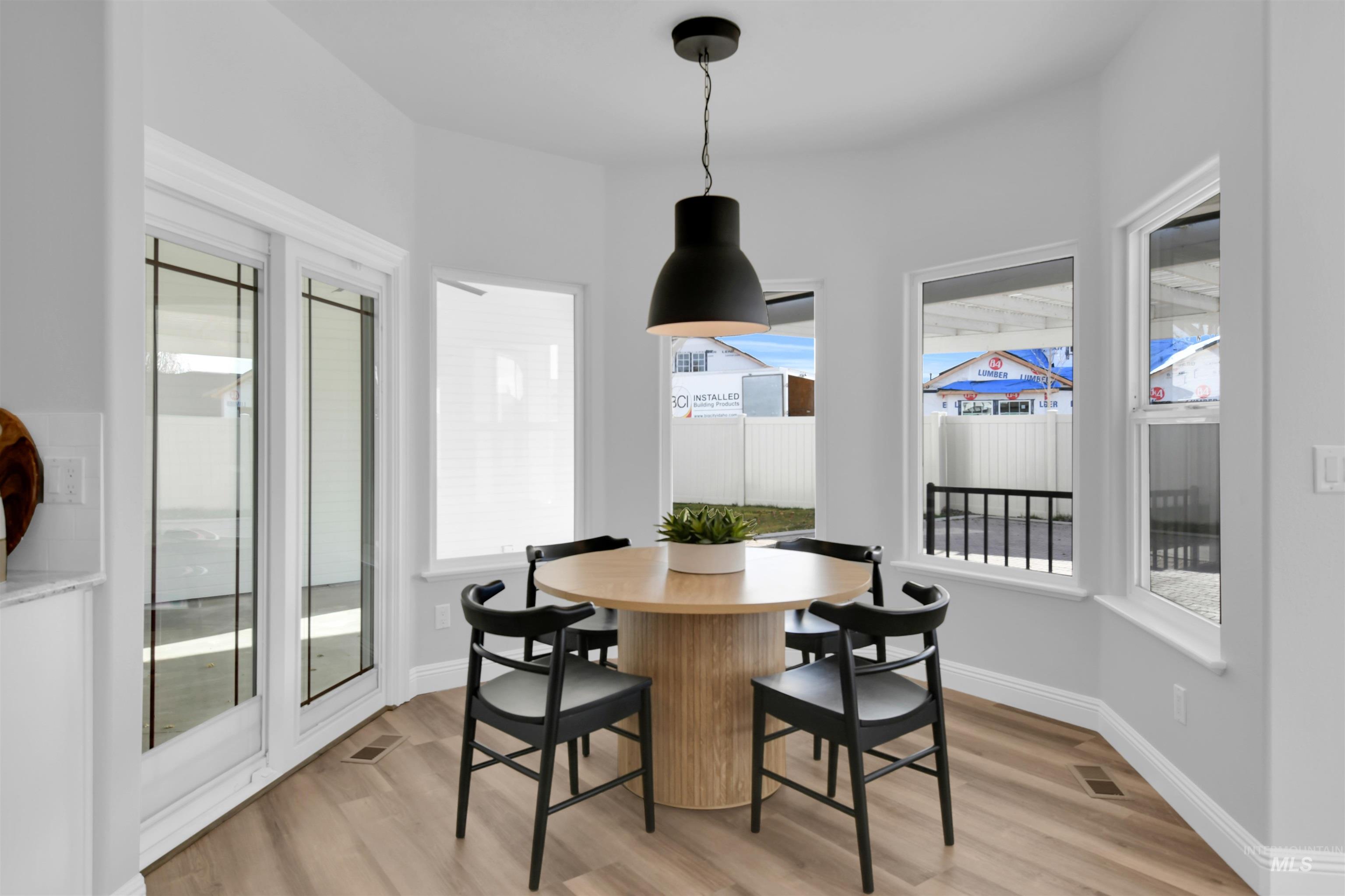 Dining room with light wood finished floors and baseboards
