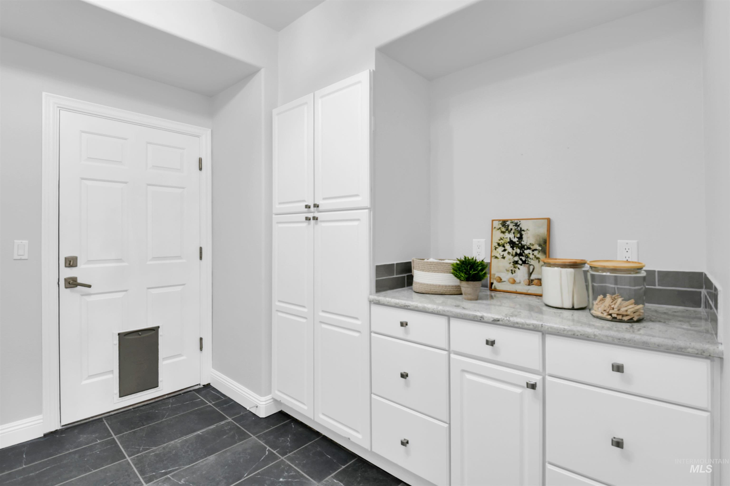 Bar featuring white cabinetry
